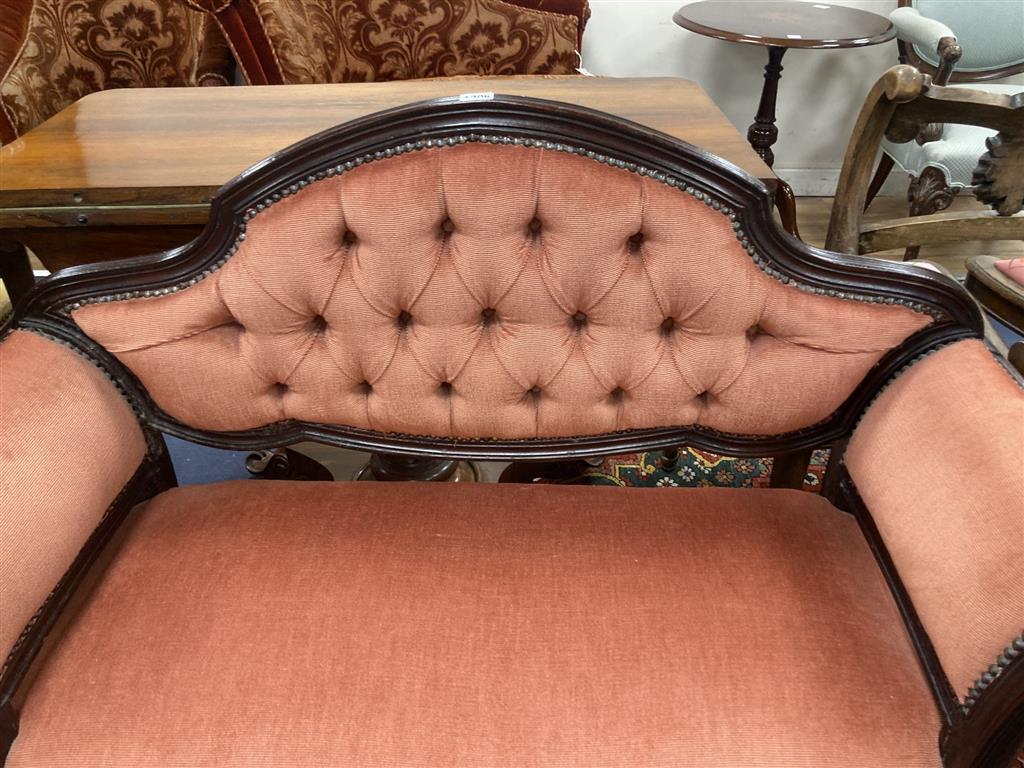 A mahogany framed two seater settee, with pink buttoned upholstery, c.1890, length 110cm, depth 42cm, height 86cm